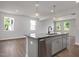 Kitchen island with a stainless steel dishwasher and granite countertop overlooking dining area at 224 Wild Turkey Way, Lillington, NC 27546