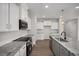Well-equipped kitchen with stainless steel appliances, granite counters, central island, and gray cabinets at 224 Wild Turkey Way, Lillington, NC 27546