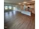 Spacious open-concept living area featuring wood-look flooring, natural light, and modern kitchen at 224 Wild Turkey Way, Lillington, NC 27546