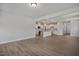 Open concept living space featuring kitchen with island, stainless steel appliances and wood flooring at 224 Wild Turkey Way, Lillington, NC 27546