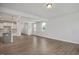 Living space showcasing open concept kitchen, modern lighting, and wood floors at 224 Wild Turkey Way, Lillington, NC 27546