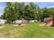 A spacious, fenced backyard features mature trees, a swing and a fire pit, ideal for relaxation and entertaining at 229 Hocutt Farm Dr Dr, Clayton, NC 27527