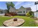 A picturesque backyard includes a fire pit, deck, mature trees, and well-maintained lawn for serene outdoor living at 229 Hocutt Farm Dr Dr, Clayton, NC 27527