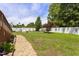 A verdant backyard showcases a stone pathway, a pristine lawn, and charming swing set, perfect for leisure at 229 Hocutt Farm Dr Dr, Clayton, NC 27527