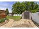 The backyard features a shed, manicured stone path, a lush lawn, and a charming swing set, offering outdoor enjoyment at 229 Hocutt Farm Dr Dr, Clayton, NC 27527