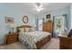 Cozy bedroom with two windows, light blue walls and classic wooden furniture at 229 Hocutt Farm Dr Dr, Clayton, NC 27527
