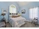 Comfortable bedroom featuring a vaulted ceiling and abundant natural light from a large window at 229 Hocutt Farm Dr Dr, Clayton, NC 27527