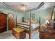 Green bedroom with tray ceiling, a four-poster bed, and matching furniture at 229 Hocutt Farm Dr Dr, Clayton, NC 27527