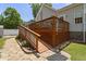 A multi-level deck features wood railings, stone accents, and blooming flowers, enhancing outdoor enjoyment at 229 Hocutt Farm Dr Dr, Clayton, NC 27527