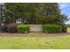 The landscaped community entrance features stone signage, lush greenery, and manicured lawn at 229 Hocutt Farm Dr Dr, Clayton, NC 27527