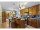 Well-equipped kitchen with wood cabinetry, stainless steel appliances, and a breakfast bar for casual dining at 229 Hocutt Farm Dr Dr, Clayton, NC 27527