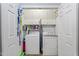 Efficient laundry room with white washer, dryer, and overhead storage cabinets at 229 Hocutt Farm Dr Dr, Clayton, NC 27527