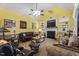 Inviting living room with a fireplace, leather seating, and lots of natural light at 229 Hocutt Farm Dr Dr, Clayton, NC 27527