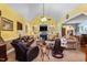 Spacious living room with yellow walls, fireplace, and plush leather furniture at 229 Hocutt Farm Dr Dr, Clayton, NC 27527