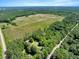 An aerial perspective shows the property's home and pool amidst lush, dense woods at 25 Misty Way, Franklinton, NC 27525