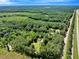 Vast aerial view showing properties nestled in extensive woodlands near a highway, offering serene seclusion at 25 Misty Way, Franklinton, NC 27525