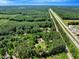 Extensive aerial view showing a house next to a highway amid vast woodlands and neighboring properties at 25 Misty Way, Franklinton, NC 27525
