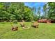 Charming backyard featuring a fire pit, wooden chairs, lush lawn, and a cozy deck area for entertaining at 25 Misty Way, Franklinton, NC 27525