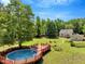 Spacious backyard with a full deck, swimming pool, lush greenery and relaxing outdoor living space at 25 Misty Way, Franklinton, NC 27525