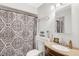 Bathroom with patterned shower curtain, neutral paint, and vanity with tan colored countertop at 25 Misty Way, Franklinton, NC 27525