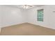 This bedroom features neutral carpet, a window that provides natural light, and a ceiling fan at 25 Misty Way, Franklinton, NC 27525