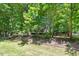Well-maintained front yard featuring mature trees and lush greenery providing ample shade and curb appeal at 25 Misty Way, Franklinton, NC 27525