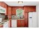 Cozy kitchen features granite countertops, tile backsplash, white appliances, and wood cabinets at 25 Misty Way, Franklinton, NC 27525
