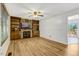 Inviting living room with hardwood floors, stone fireplace, built-in bookshelves, and an abundance of natural light at 25 Misty Way, Franklinton, NC 27525