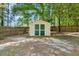 Well-maintained storage shed in a fenced backyard, providing extra space for tools and outdoor equipment at 25 Misty Way, Franklinton, NC 27525