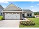 Charming new construction home featuring a two-car garage, stone accents, and beautifully landscaped front yard at 30 Elmwood Ave, Sanford, NC 27330