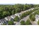 Aerial view showcasing a neighborhood with lush tree coverage and well-maintained homes, perfect for nature lovers at 3021 Remington Oaks Cir, Cary, NC 27519