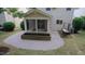 The backyard patio area features comfortable seating, a screened-in porch, and landscaping at 3021 Remington Oaks Cir, Cary, NC 27519