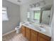 Bathroom features a double sink vanity, toilet, and separate soaking tub with a window view at 3021 Remington Oaks Cir, Cary, NC 27519