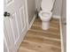Bathroom featuring a toilet and light wood flooring at 3021 Remington Oaks Cir, Cary, NC 27519