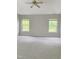 Bedroom featuring a ceiling fan, two windows, and carpet at 3021 Remington Oaks Cir, Cary, NC 27519