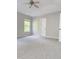Bedroom featuring a window, carpet, ceiling fan, and a white door at 3021 Remington Oaks Cir, Cary, NC 27519