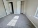 Bright bedroom features neutral carpet, closet, and trim throughout at 3021 Remington Oaks Cir, Cary, NC 27519