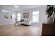 Bright living room with stylish decor, wood floors and large windows at 3021 Remington Oaks Cir, Cary, NC 27519