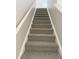 Carpeted staircase leading to the upper level of the home at 3021 Remington Oaks Cir, Cary, NC 27519