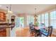 Charming dining room featuring hardwood floors, plantation shutters, and a classic chandelier at 3197 Carriage Creek Ct, Haw River, NC 27258