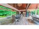 The dining room seamlessly merges indoor and outdoor living with its retractable glass walls and an elegant chandelier at 3197 Carriage Creek Ct, Haw River, NC 27258