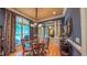 Refined dining area with hardwood floors, stylish furnishings, large windows, and sophisticated decor at 3197 Carriage Creek Ct, Haw River, NC 27258