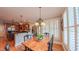 Bright dining area with wood floors, large windows, and a view into the kitchen at 3197 Carriage Creek Ct, Haw River, NC 27258