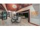 Open-concept dining area featuring a modern chandelier and seamless transition to the outdoor patio and bar area at 3197 Carriage Creek Ct, Haw River, NC 27258