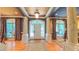Grand foyer with gleaming hardwood floors, ornate columns, and a decorative leaded glass front door at 3197 Carriage Creek Ct, Haw River, NC 27258