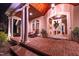 Welcoming front porch with brick flooring, columns, wood ceiling, leaded glass door, and a cozy chair at 3197 Carriage Creek Ct, Haw River, NC 27258