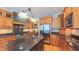 Elegant kitchen featuring custom wood cabinets, stainless steel appliances, and a granite-topped center island at 3197 Carriage Creek Ct, Haw River, NC 27258