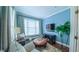 Cozy blue living room features comfortable seating, built-in entertainment center and soothing ambiance at 3197 Carriage Creek Ct, Haw River, NC 27258