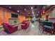 Open living area featuring a stone fireplace, pool table, full bar, and seating area at 3197 Carriage Creek Ct, Haw River, NC 27258