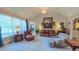 Inviting living room featuring large windows, neutral decor, and comfortable leather seating at 3197 Carriage Creek Ct, Haw River, NC 27258